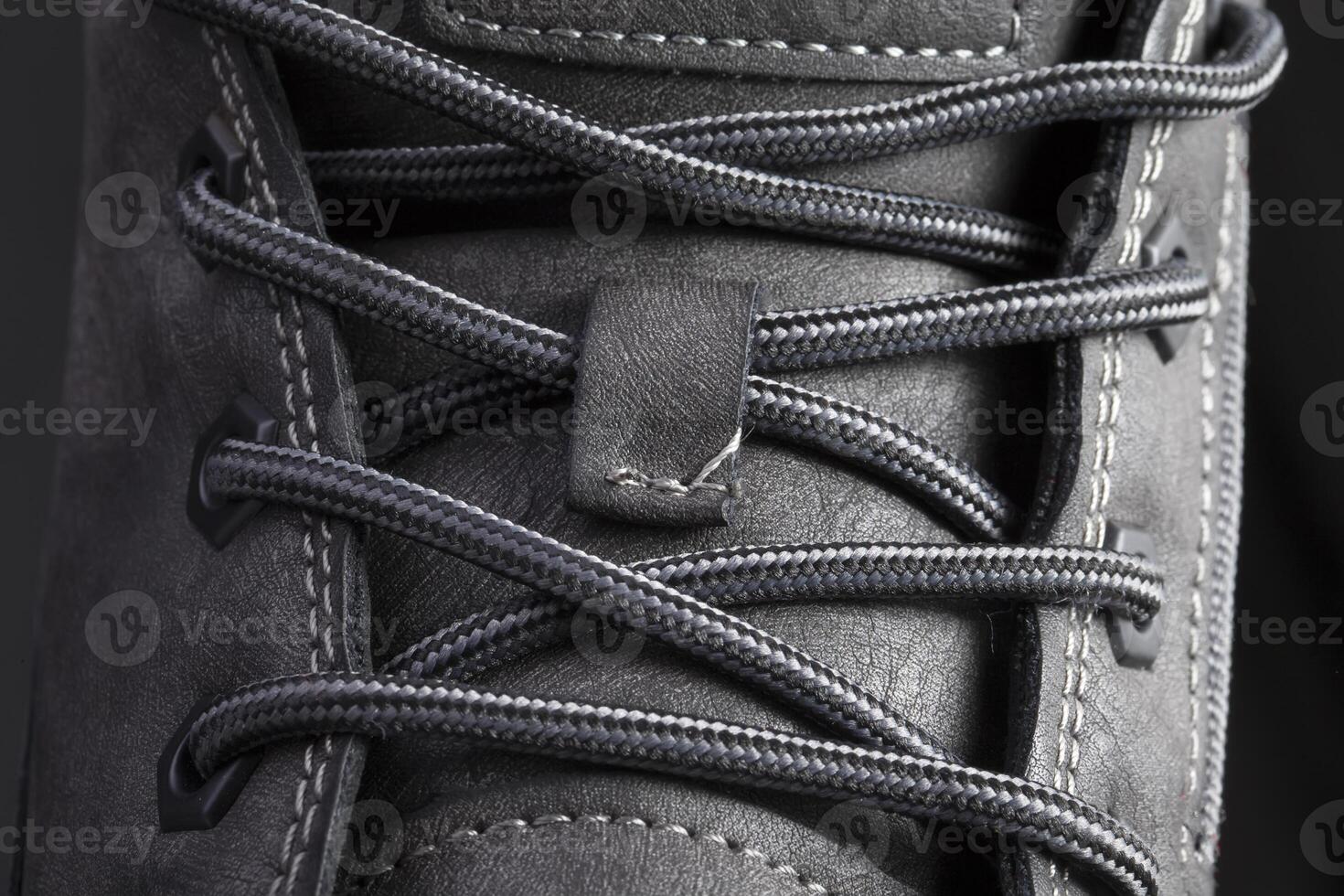 Part of a leather boot close-up. A fragment of the texture of leather shoes. photo