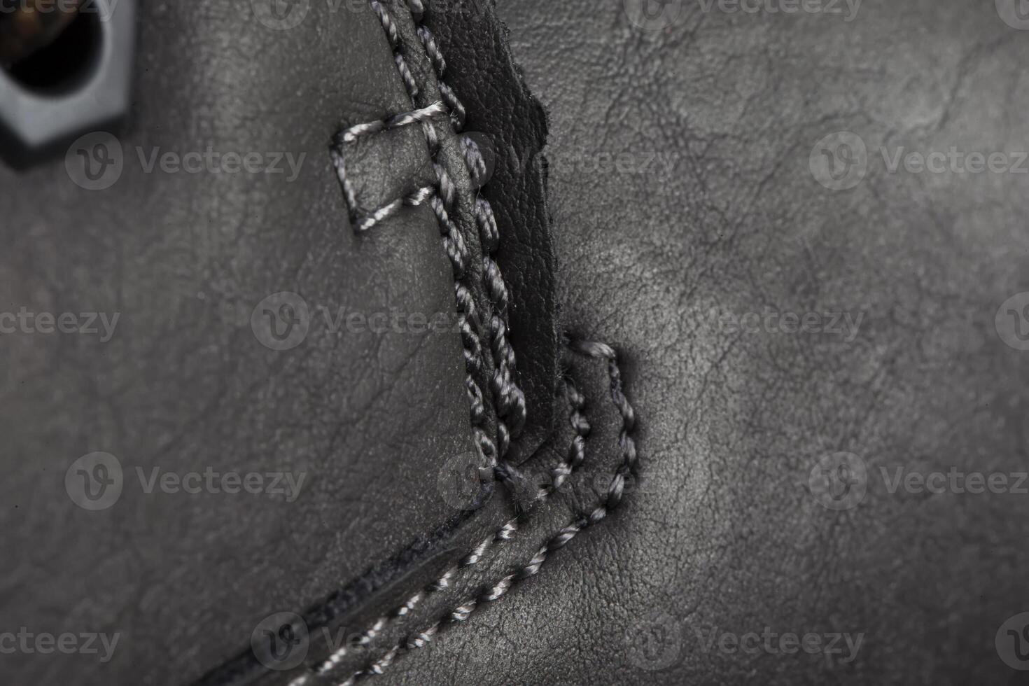 Part of a leather boot close-up. A fragment of the texture of leather shoes. photo