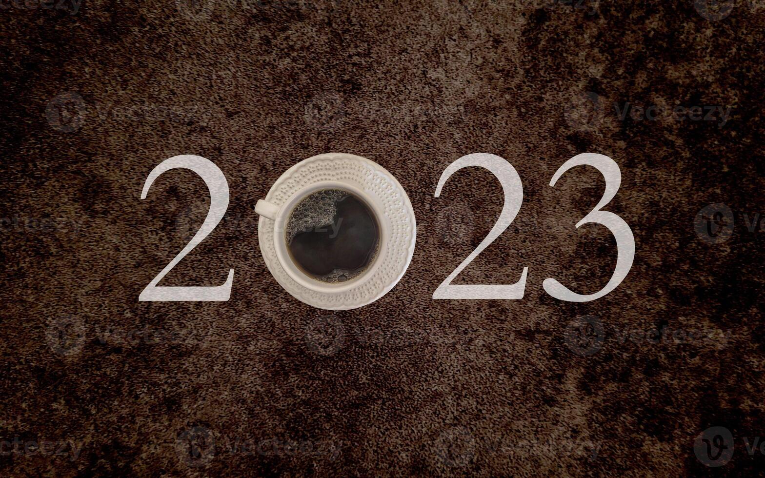 coffee with white cup with dark background written 2023, happy new year 2023 photo