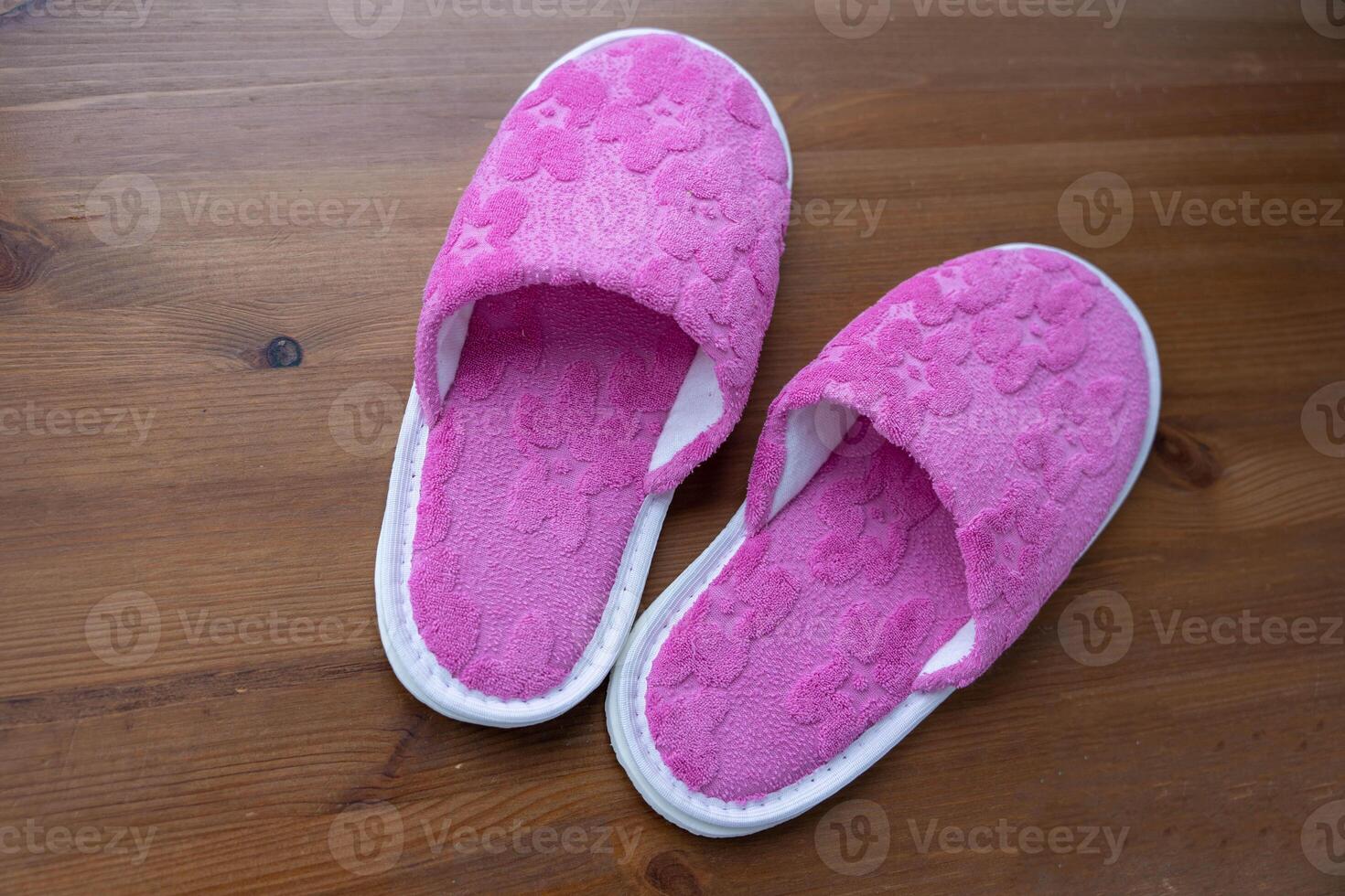 Pink Slippers on Wooden Floor photo