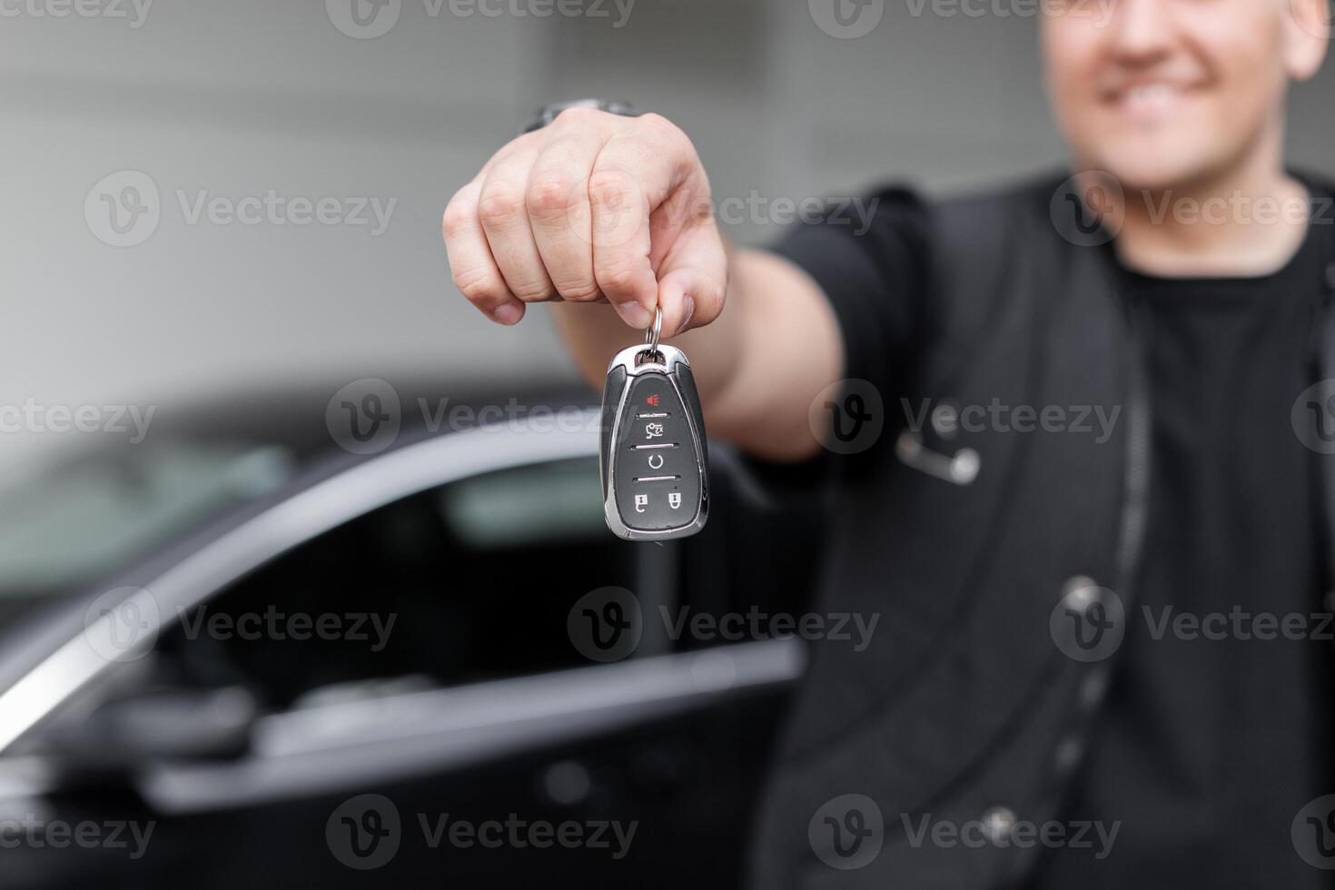 Happy man holding and giving car keys. Arneda auto. Sale of transport photo