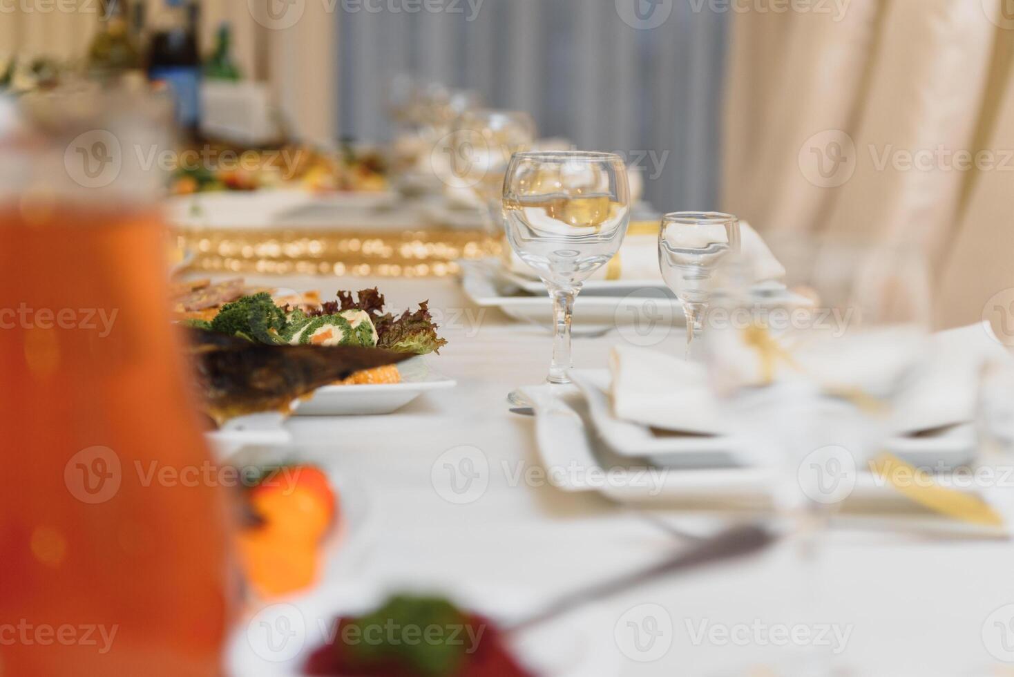 Glasses on the festive table setting. Wedding table decor concept. Table setting in classic style, setout. fine art. photo