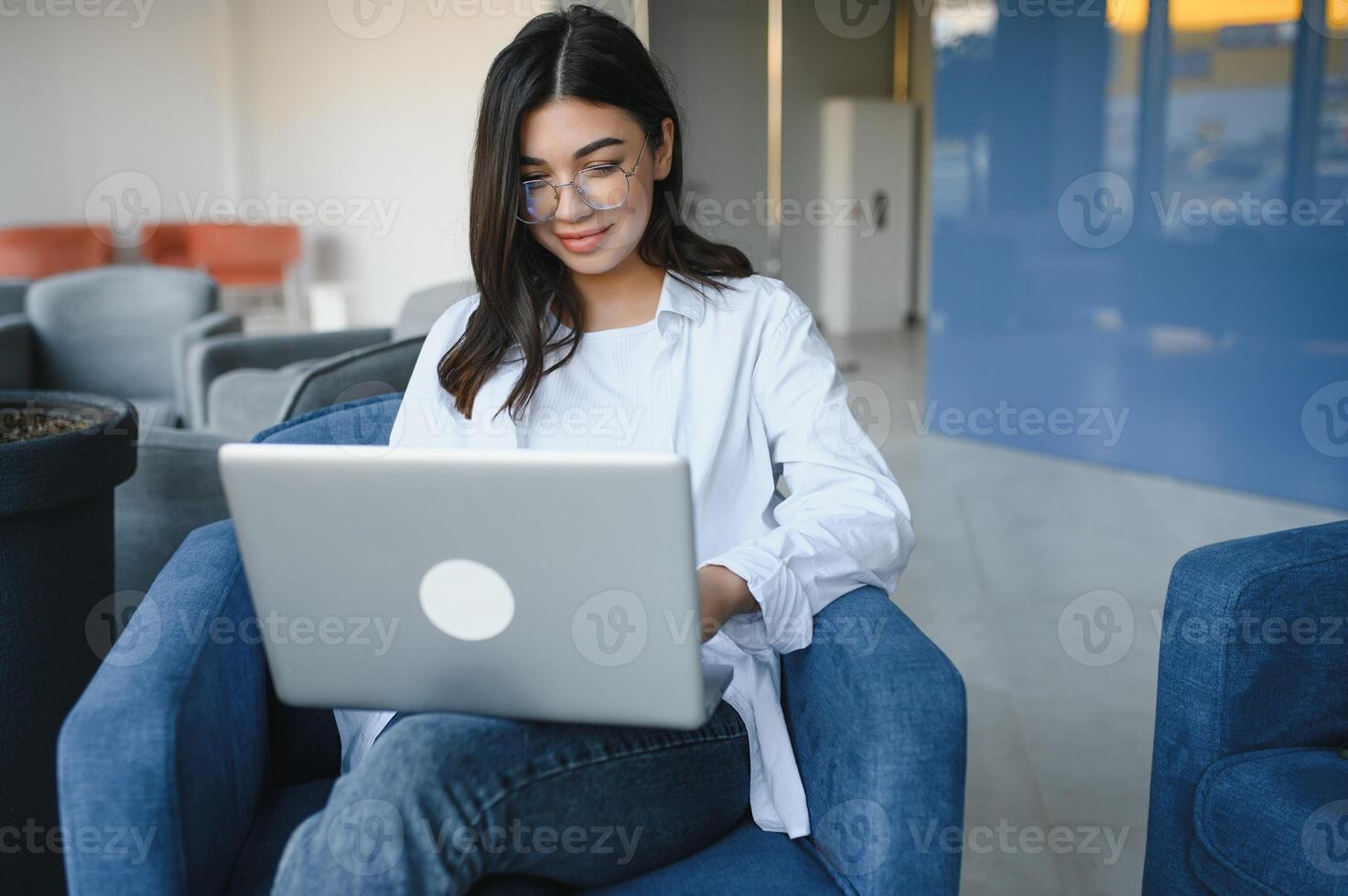 Beautiful Caucasian woman dreaming about something while sitting with portable net-book in modern cafe bar, young charming female freelancer thinking about new ideas during work on laptop computer photo
