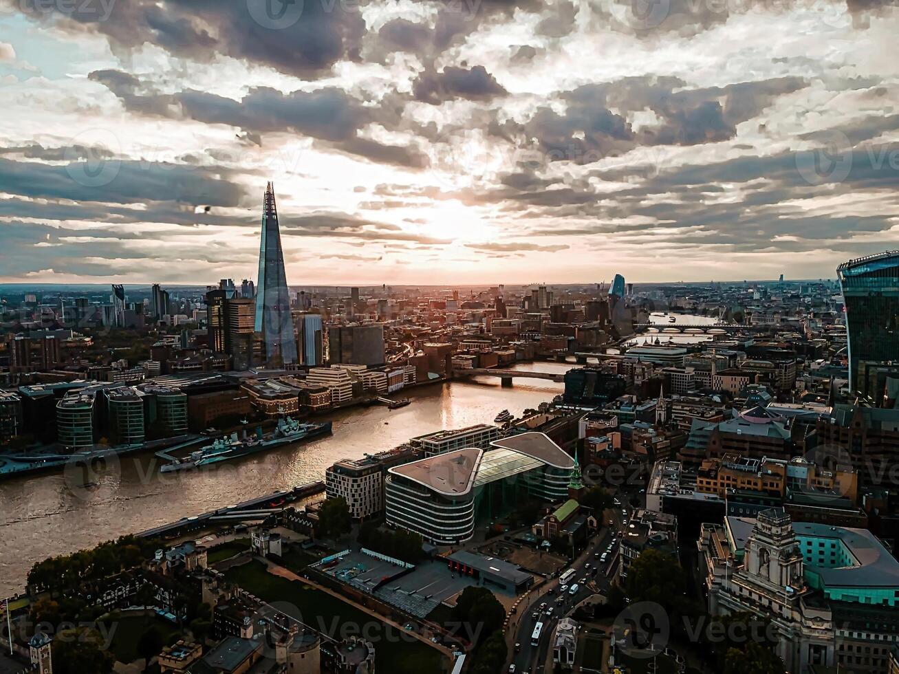 Expansive London Cityscape with Tower Bridge and the Shard Under Moody Skies photo