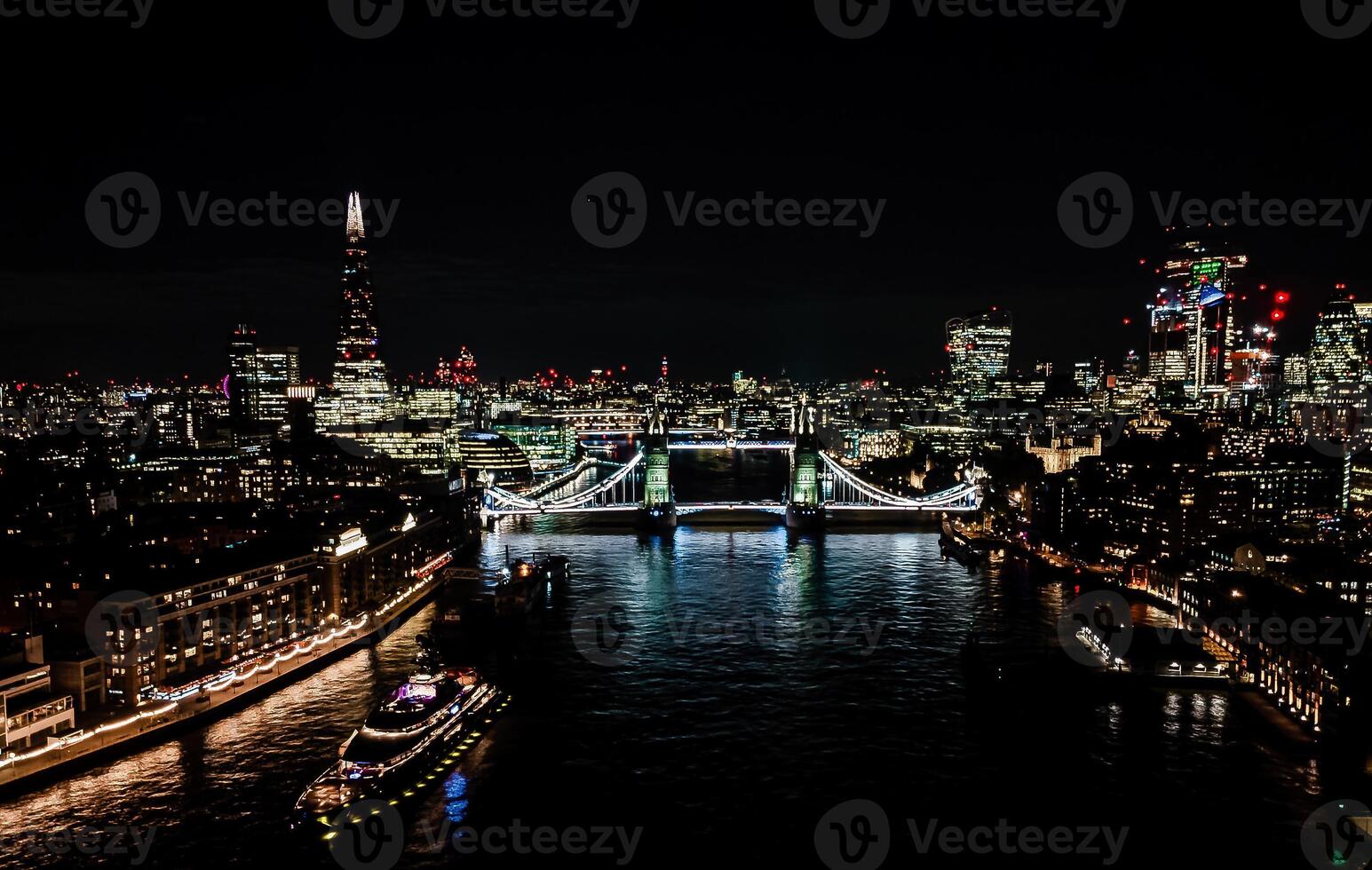 London's Tower Bridge Glows Brightly Against the Twilight Sky, Offering a Stunning Sight from High Above photo