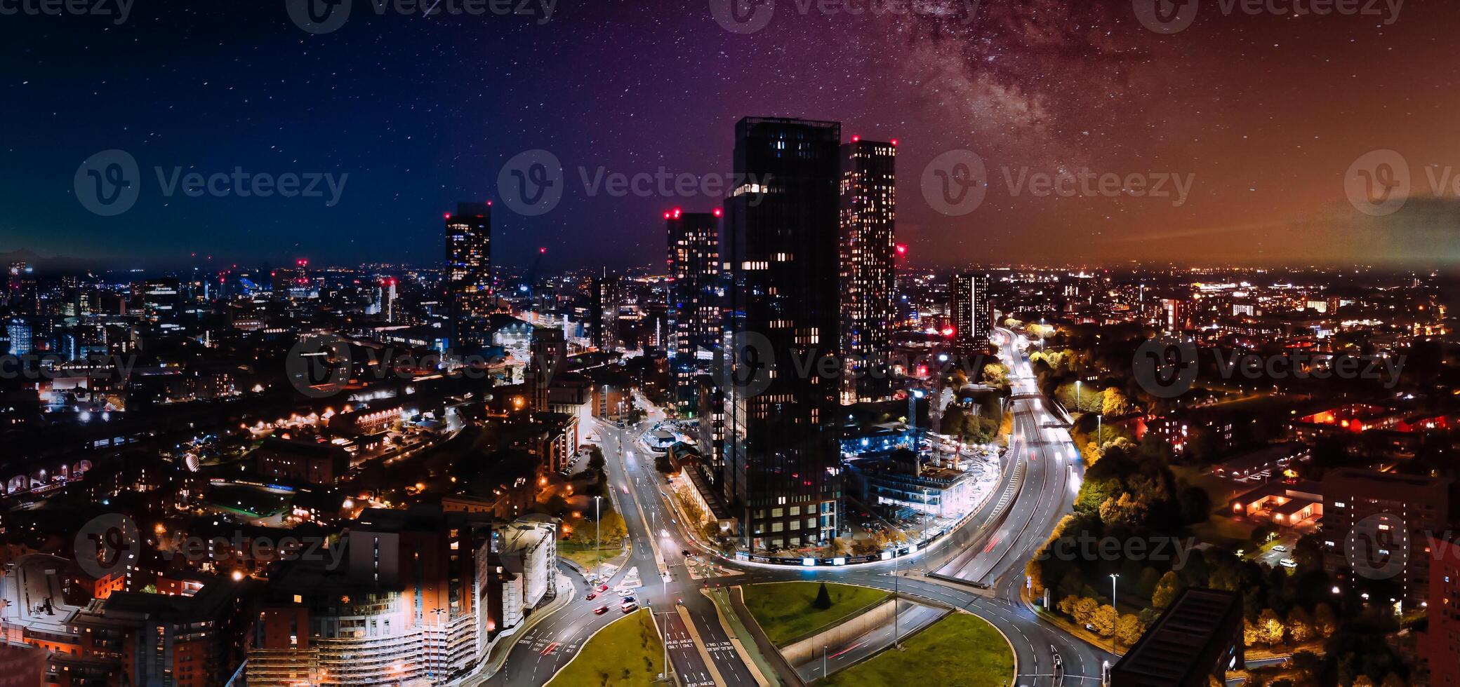 Beautiful Aerial drone view of Manchester city in UK at night. Night skyscrapers standing in the city lights. photo