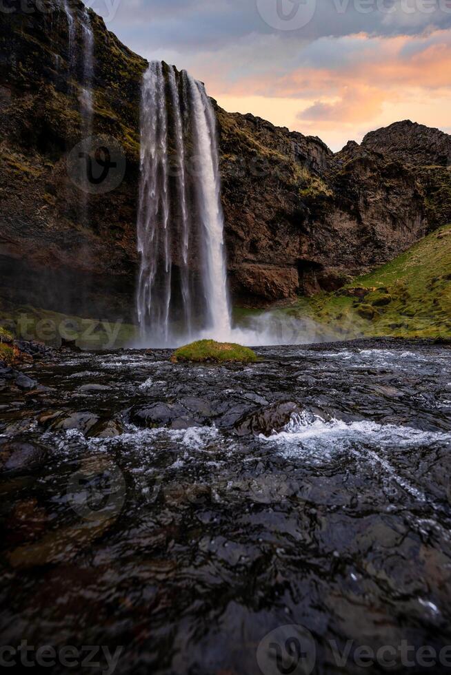 Stunning Seljalandsfoss Waterfall at Sunset, One of Icelands Most Popular and Breathtaking Natural Wonders photo