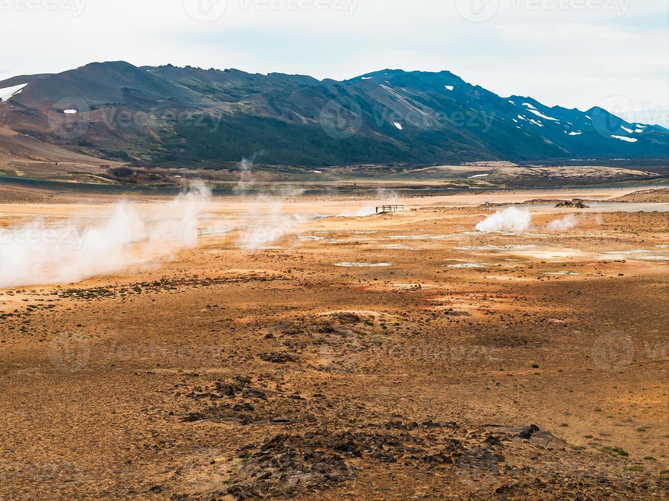 Aerial view of Hverir Geothermal Area in Iceland, capturing boiling mud pools, fumaroles, and the dramatic landscape of this geothermal hotspot near Lake Myvatn. photo