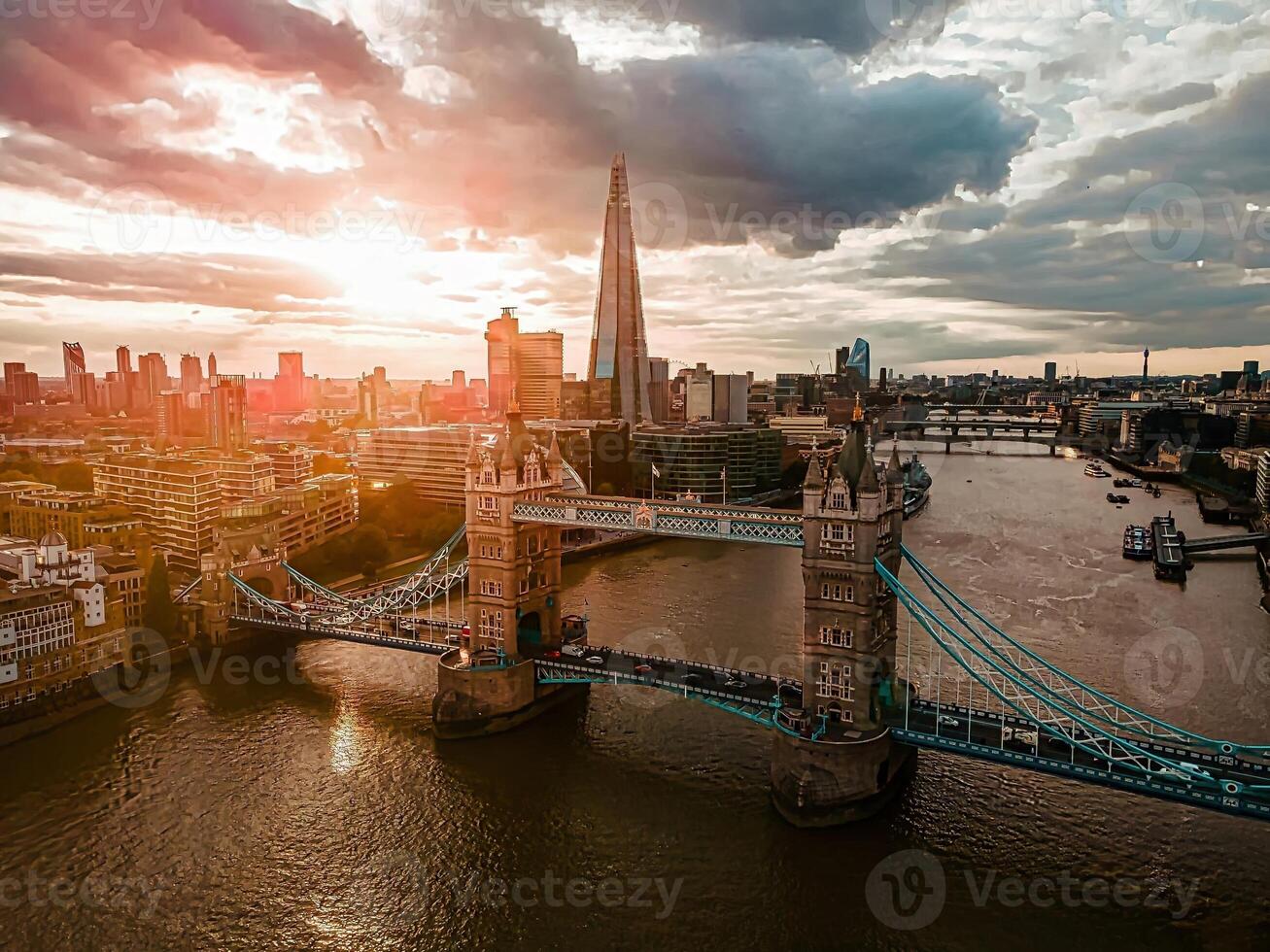 Aerial view to the Beautiful Tower Bridge and skyline of London, UK, during the sunset. photo