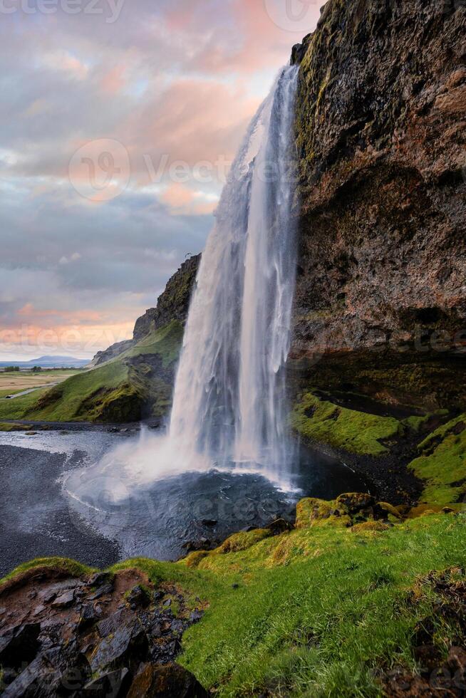 Majestic Seljalandsfoss Waterfall at Sunset in Iceland with Lush Green Landscape photo
