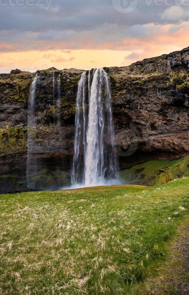 Majestic Seljalandsfoss Waterfall at Sunset in Iceland with Lush Green Landscape photo