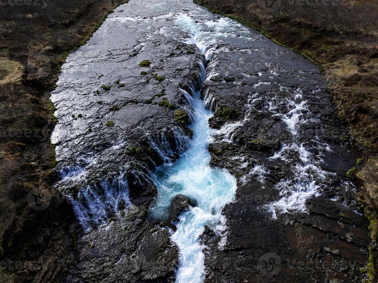 Aerial view of Bruarfoss Waterfall, Iceland's bluest waterfall with vibrant blue water flowing over stones. Most famous place in Iceland photo