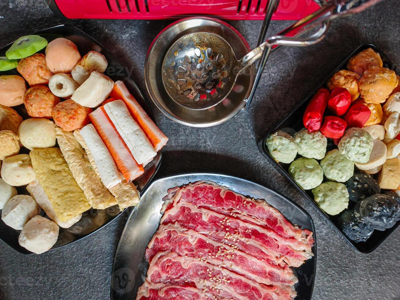 Ingredients for shabu-shabu dishes include sliced raw meat and processed ingredients for boiling which are based on seafood photo