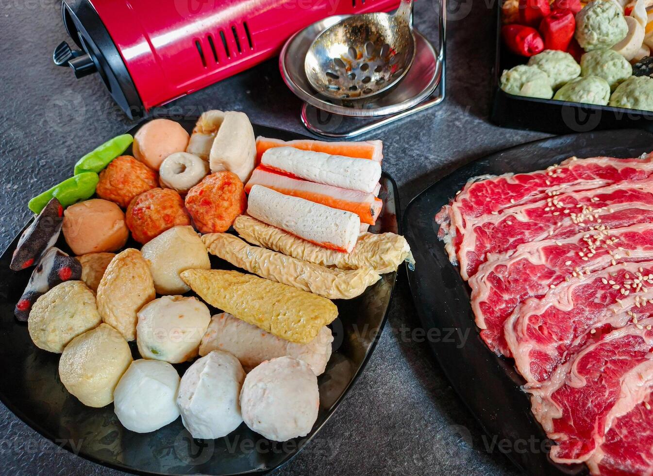Ingredients for shabu-shabu dishes include sliced raw meat and processed ingredients for boiling which are based on seafood photo