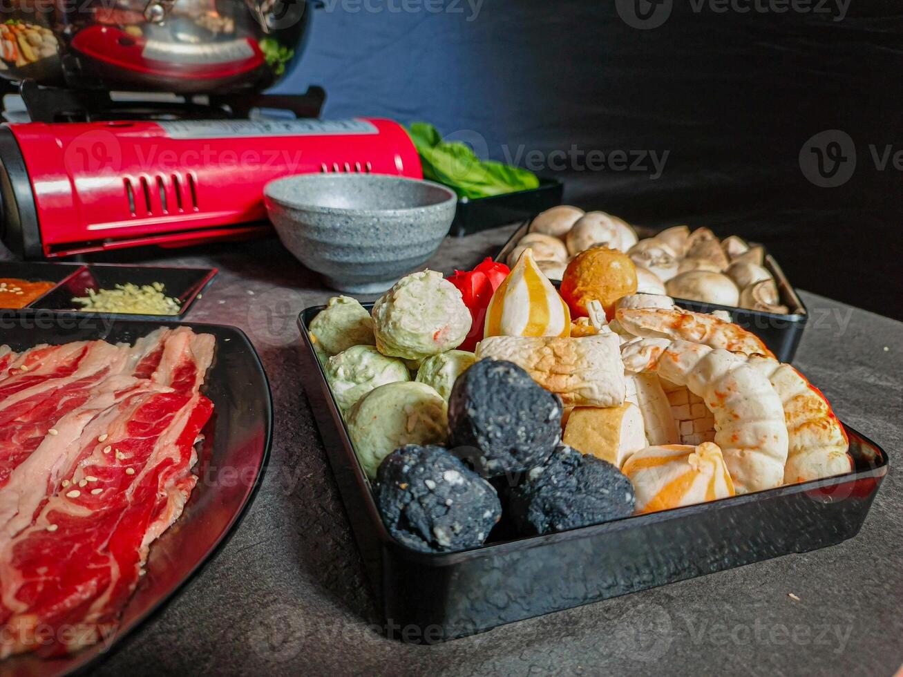 Ingredients for shabu-shabu dishes include sliced raw meat and processed ingredients for boiling which are based on seafood photo