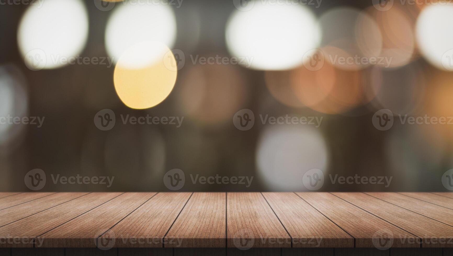Empty wooden table top with lights bokeh on blur restaurant background. photo