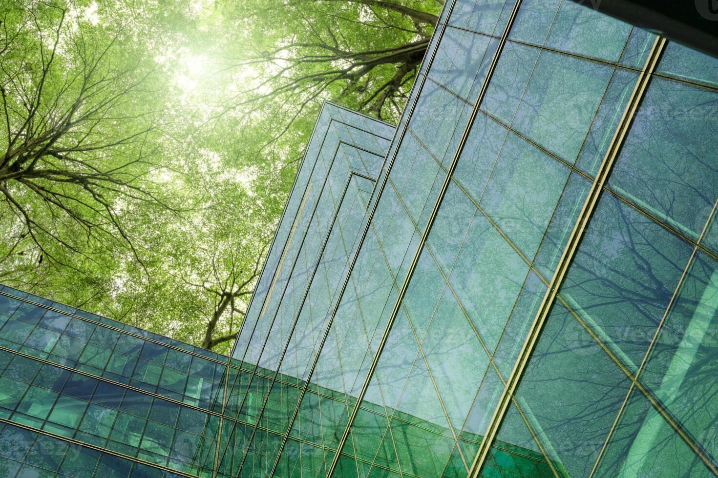 Eco-friendly building in modern city. Sustainable glass office building with trees for reducing carbon dioxide. Office building with green environment. Corporate building reduce CO2. Net zero emission photo