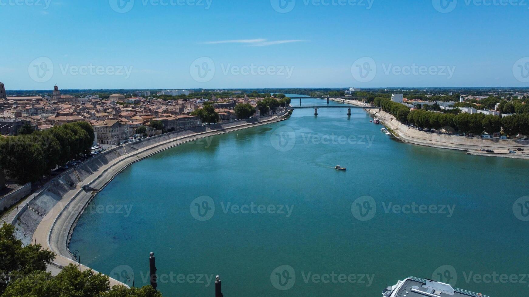 Rhone river passing through the city of Arles in Provence. Ferries and boats in the important river in Europe that flows into the Mediterranean. Towns along the river that attract tourists traveling. photo