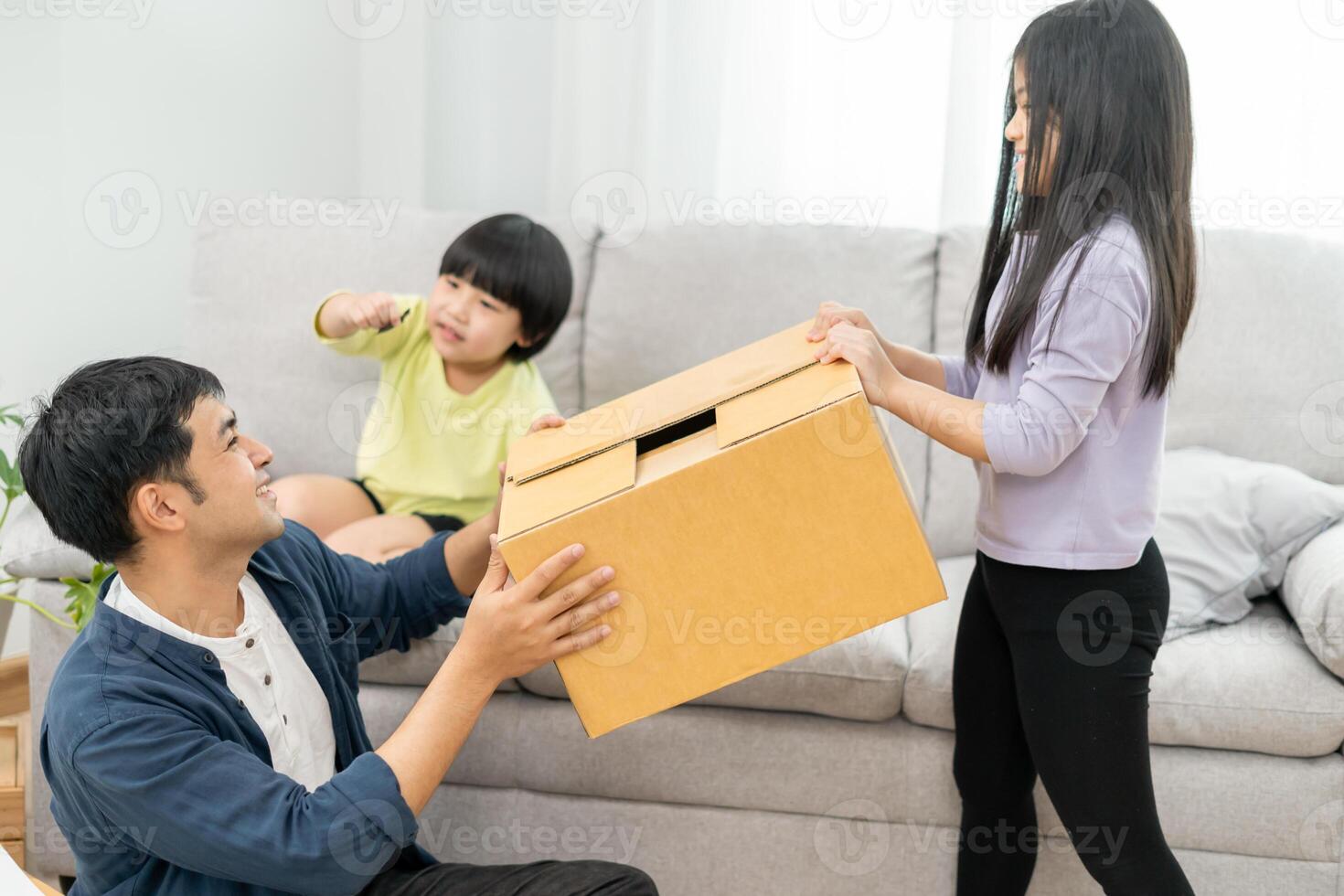 Moving house, relocation. Family smile and play together after move to new home, inside the room was a cardboard box contain personal belongings and furniture. move in the new apartment, condominium photo