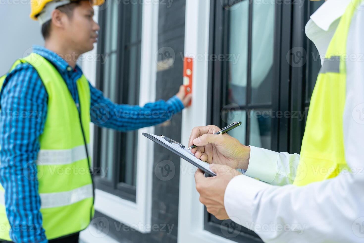 inspector or engineer is inspecting construction and quality assurance new house using a checklist. Engineers or architects or contactor work to build the house before handing it over to the homeowner photo