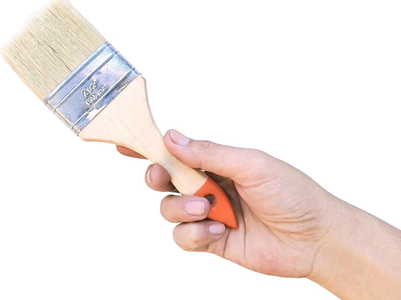 Hand holding yellow paint brush, close-up horizontal view, white background photo