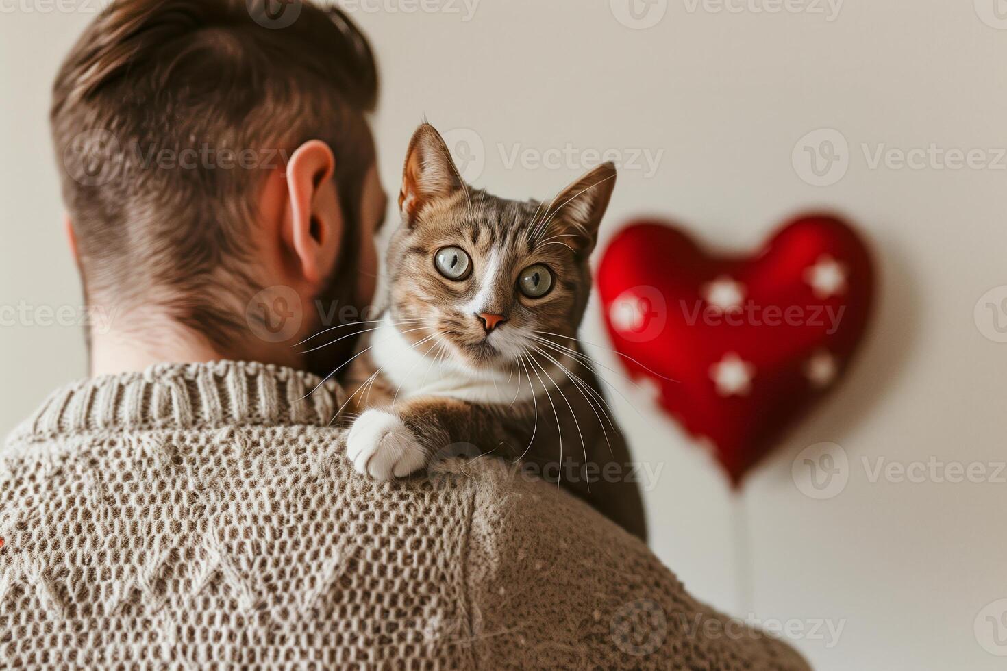 Cat, Valentine's Day Love Young Man and Tabby Cat With Red Heart Balloon in Cozy Sweater Embracing Warmth and Affection. photo