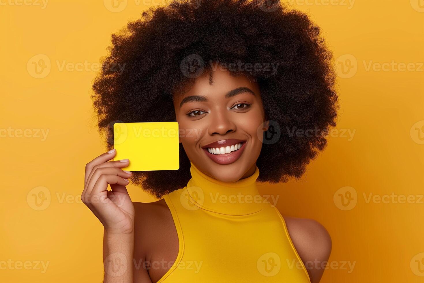 Happy Woman Holding Yellow Mockup Copy Space Card Against Vibrant Orange Background, Showcasing Bright Afro Hairstyle, Beautiful Smile, Cheerful Attitude, Advertising, Marketing, Retail Promotions photo