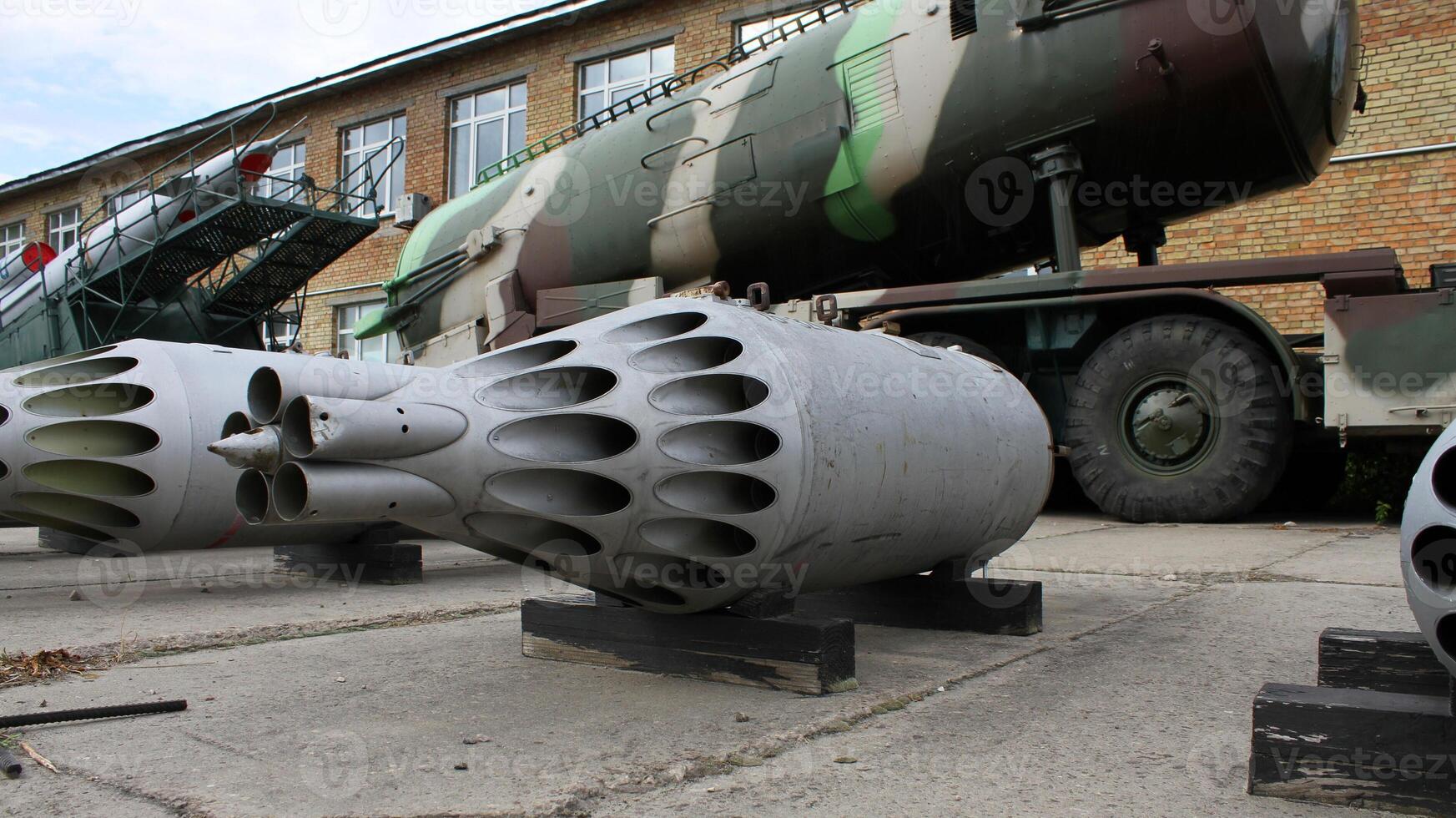 Damaged Cassette Of Aircraft Rockets In Front Of Anti-Aircraft Missile Launcher photo