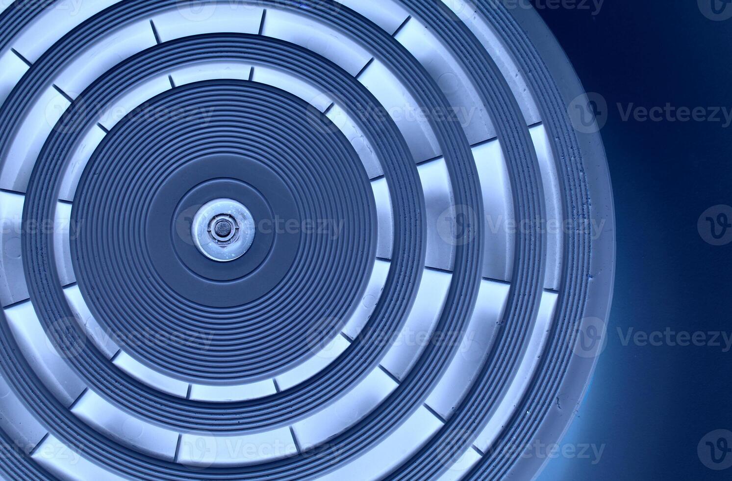 Abstract Precision Circle Texture With Blue Backlit Of Same Segments On Dark Blue Background photo