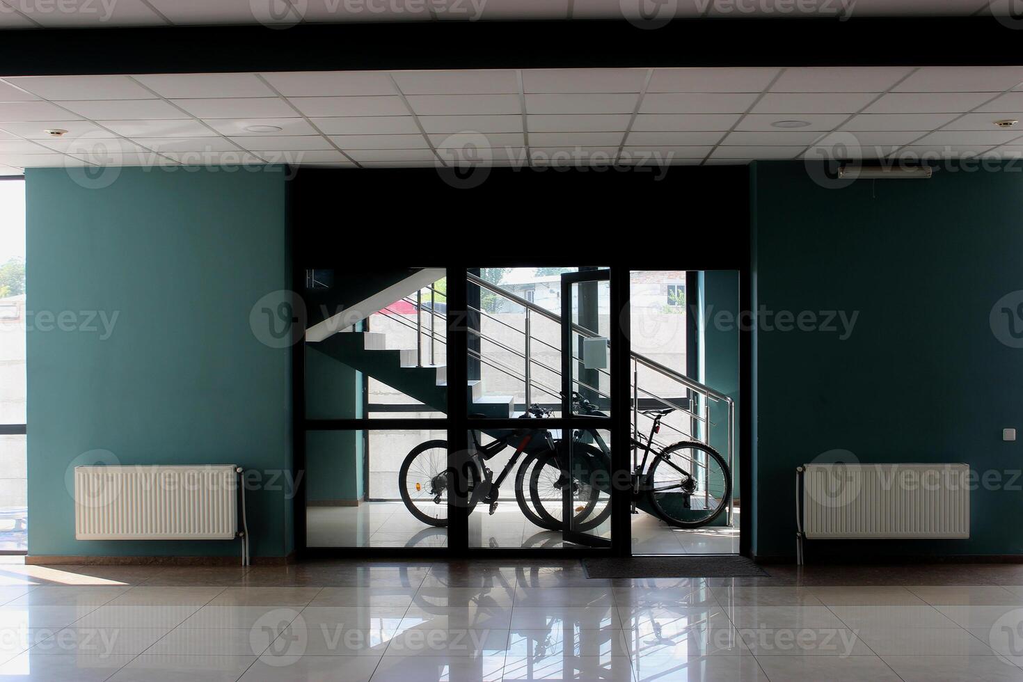 Bicycles in a special place near the stairs at the entrance to the office building. Transportation to get to work in the city. Post delivery by bicycle for office photo