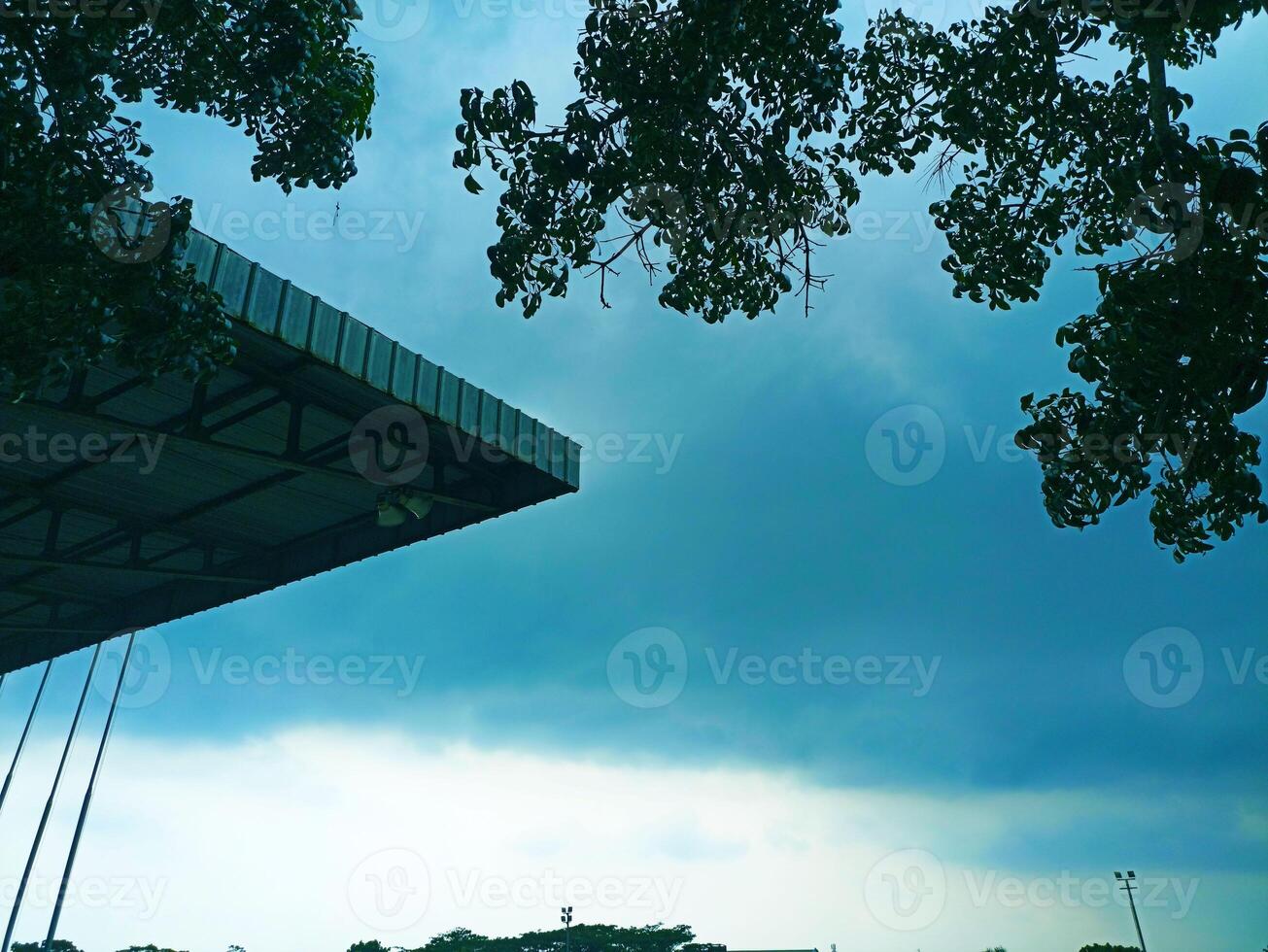 a man is flying a kite on a cloudy day photo