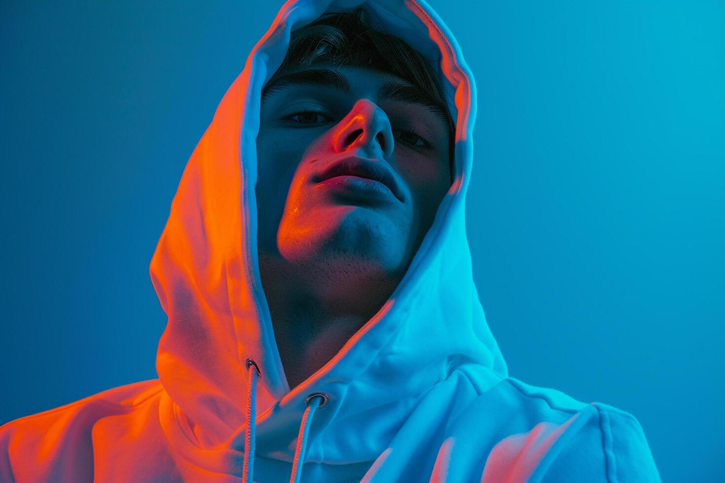 Trendsetting Male Fashion Male Model in Casual Hoodie with Neon Blue Modern portrait with Urban Setting photo