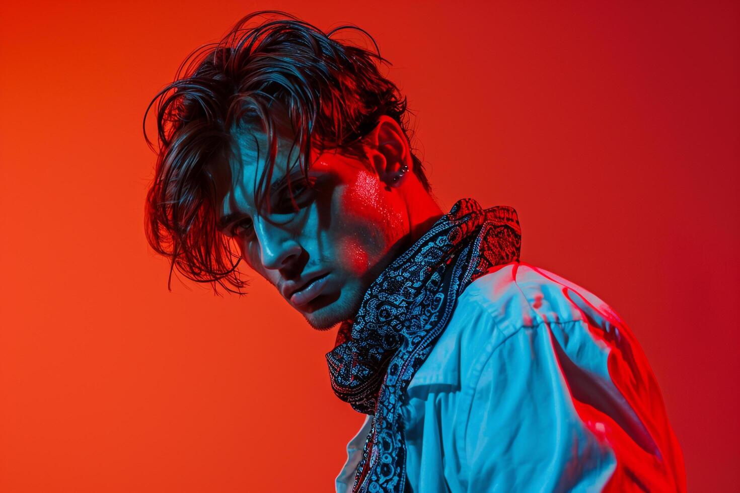 Handsome Fashion Male Model in Luxurious Bandana with Neon Red Lifestyle portrait Featuring Vibrant Neon Red Background photo
