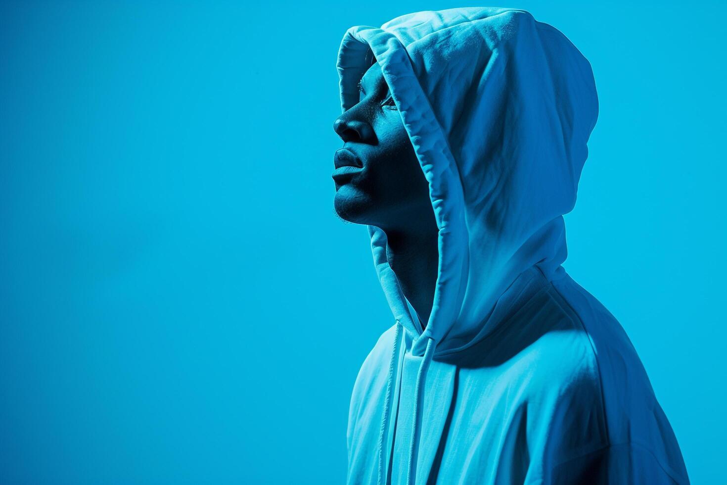 elegant Male Fashion Male Model in High end Hoodie with Soft Blue Background Trendy Urban portrait Featuring Modern Style photo