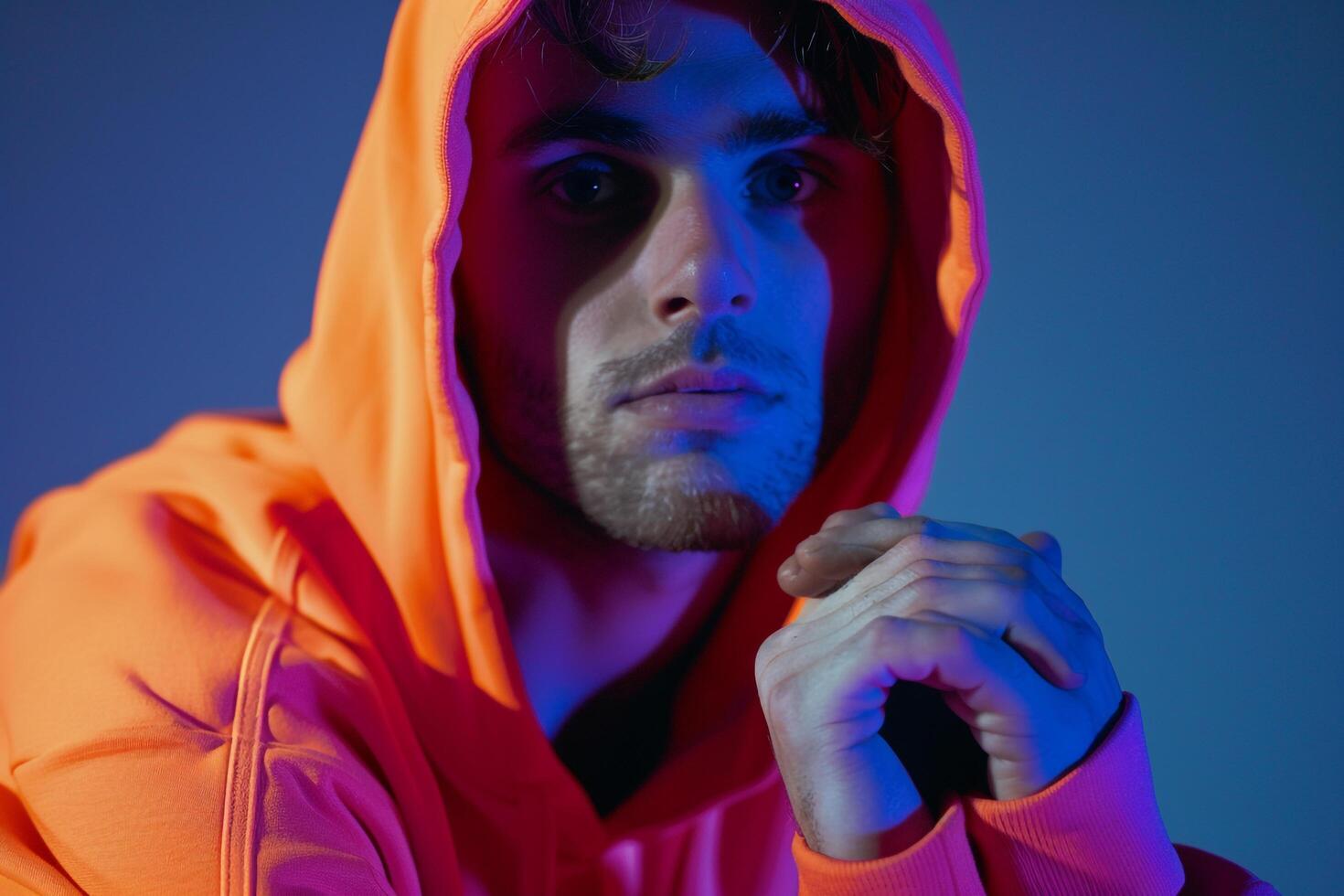 Stylish Male Model in Neon Orange Hoodie with Neon purple Background energetic Urban portrait Featuring Contemporary Fashion photo