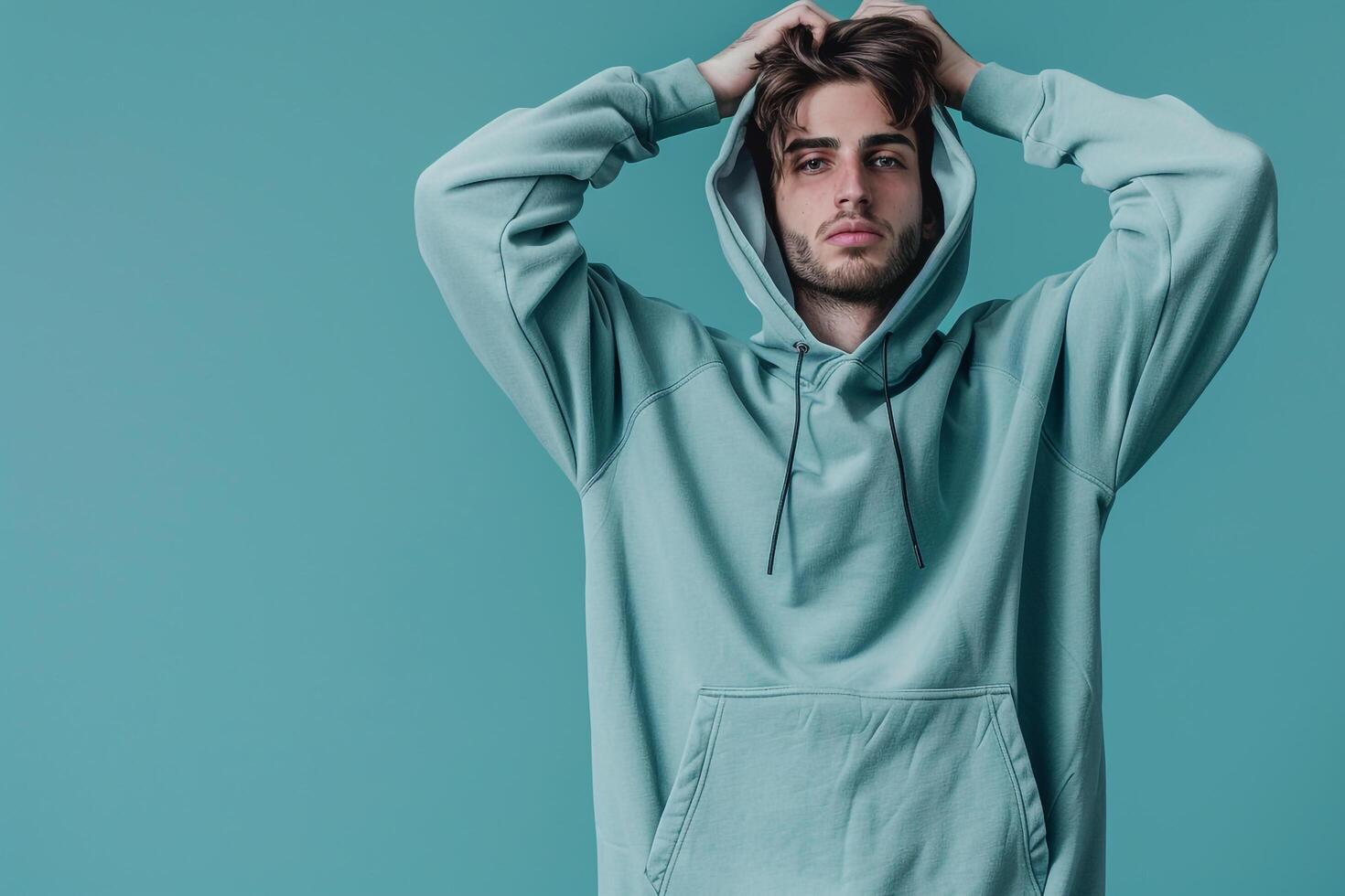 Modern Males portrait Featuring Handsome Fashion Male Model in Trendy Hoodie with Light Blue Background photo