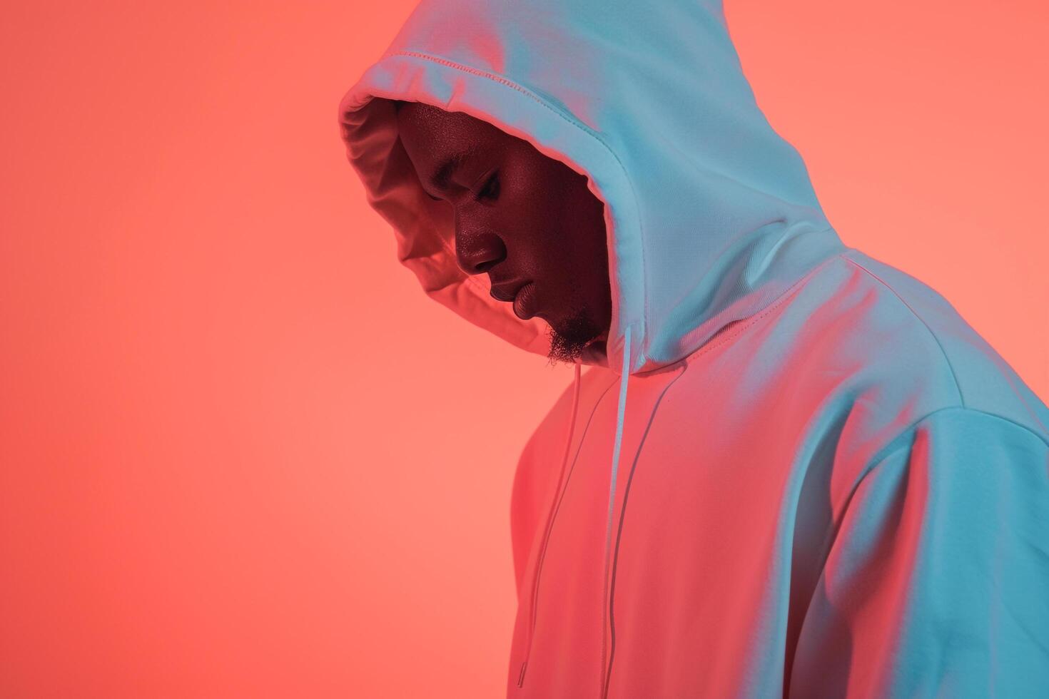 Trendy Fashion Male Model in Hoodie with Light Coral Background High end Lifestyle portrait photo