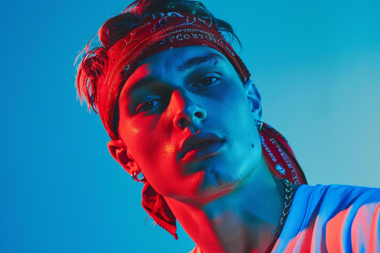 Handsome Fashion Male Model in Neon Red Bandana with Neon Blue Background Highlighting Modern Males portrait Fashion photo