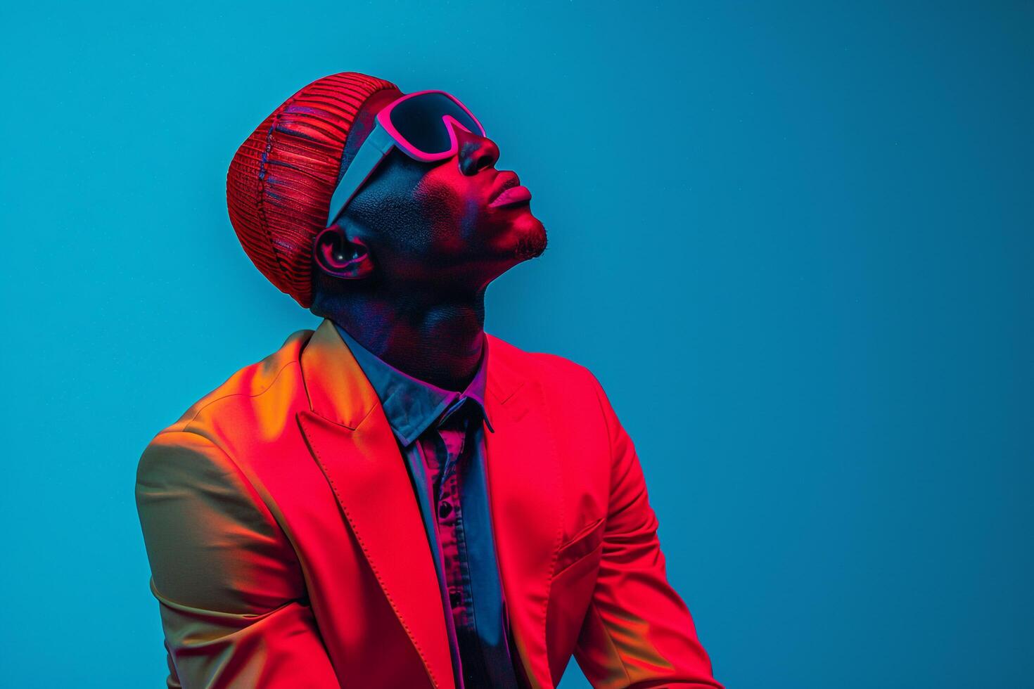 Stylish Fashion portrait of Handsome Male Model in Casual Blazer with Neon Red Sneaker Mask and Blue Lifestyle Background photo