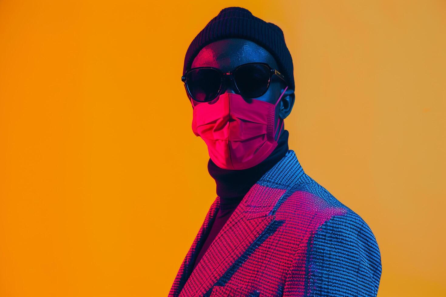 Male Fashion Model in Trendy Blazer with Neon Red Ski Mask and Yellow Background Chic portrait Featuring Contemporary Fashion Trends and Bold Colors photo