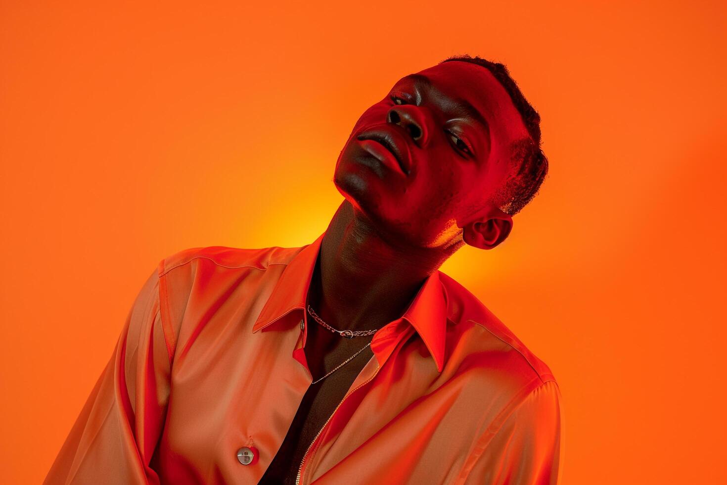 Dynamic Ambiance in Males Fashion portrait Silk Shirt with Neon Orange Background photo