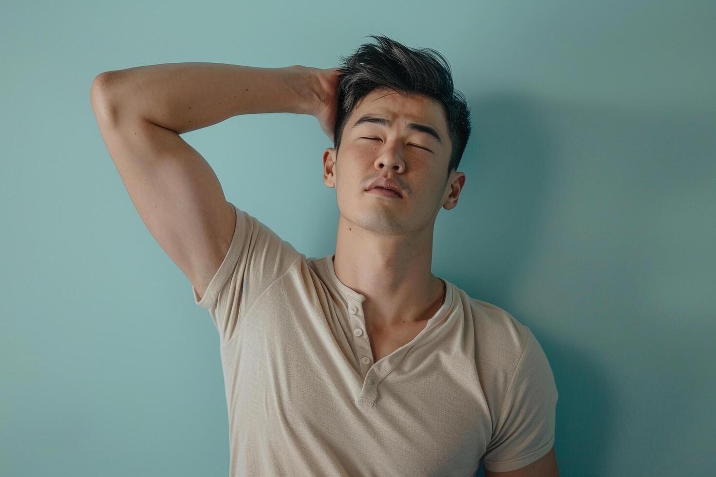 Fashion Model in Henley Shirt with Seafoam Green Background Handsome Male Dress Featuring Trendy Lifestyle and Contemporary Fashion photo