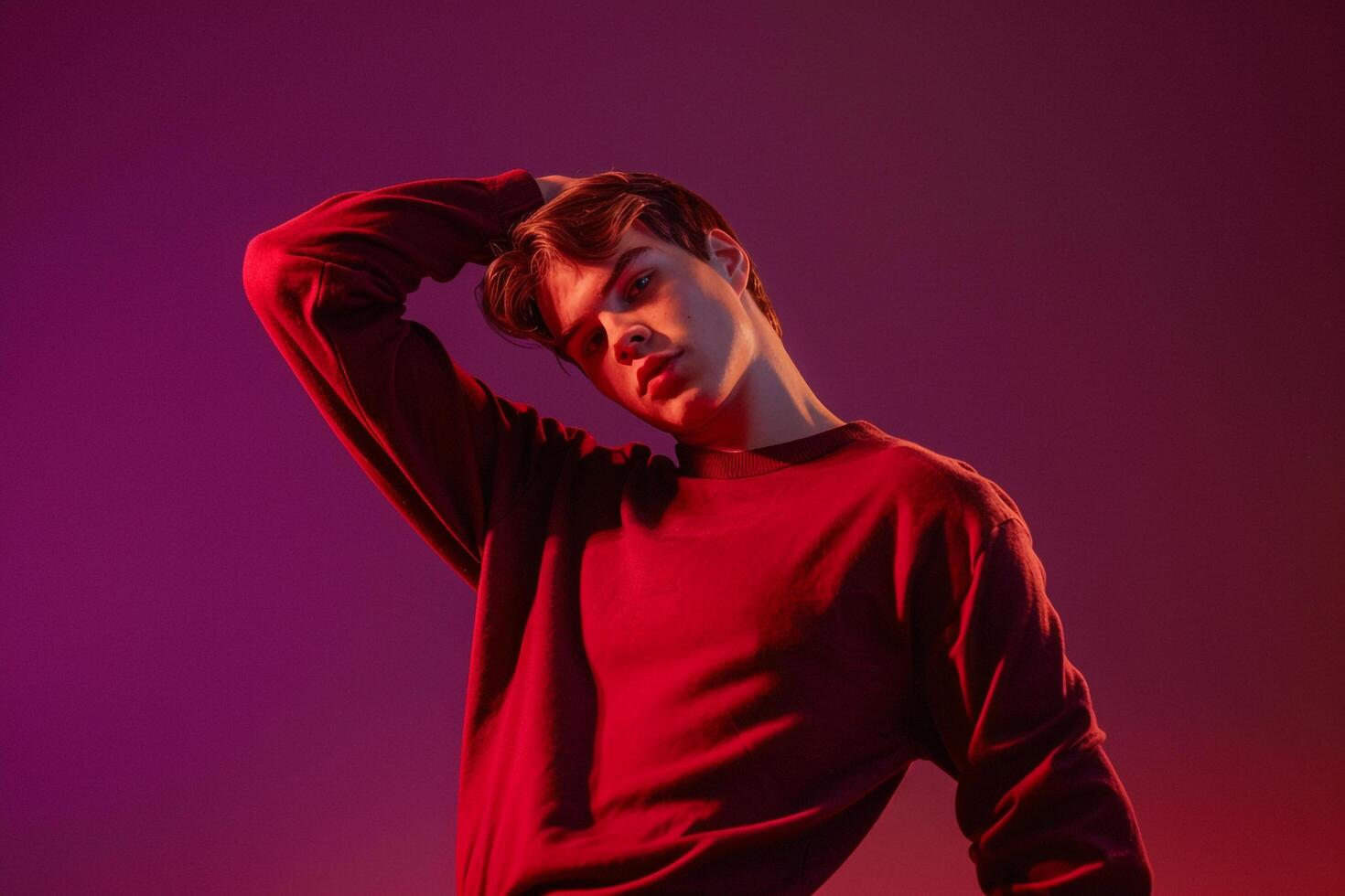 Relaxed Male Fashion Model in pullover with Deep plum Background Showcasing Comfortable Fashion Style and Casual Lifestyle photo