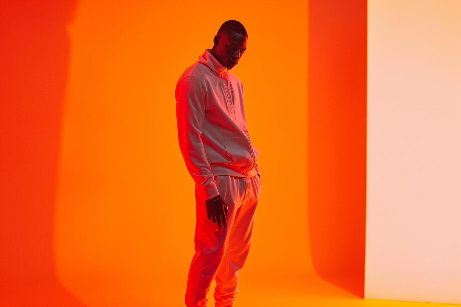 High performance Tracksuit Fashion Model Trendy Male in Neon Orange Lifestyle Setting with Stylish Background Dynamic and Modern Look photo