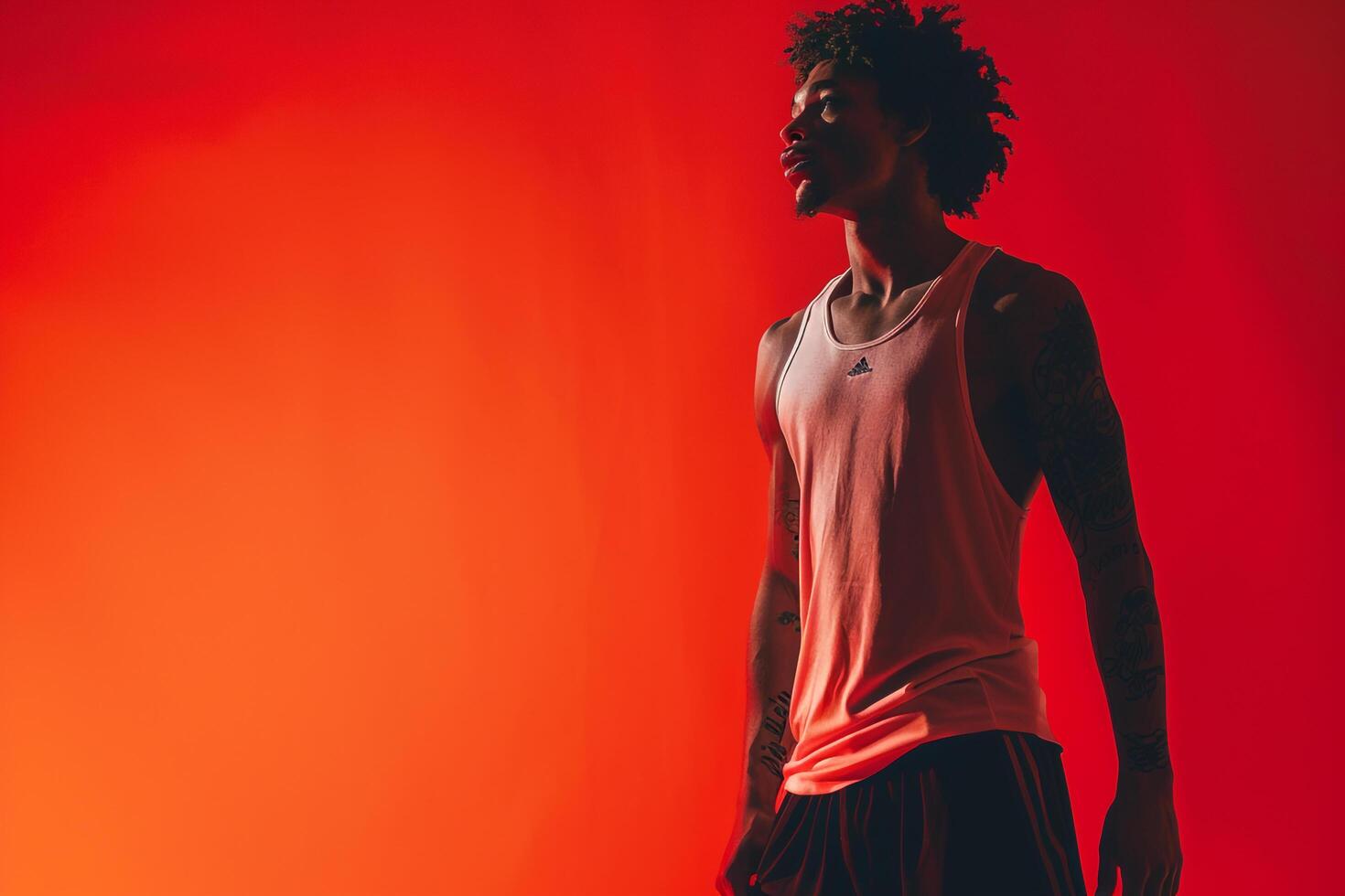 Athletic Shorts and Tank Top Fashion Model in Bright Red Fashionable Male portrait with Modern Lifestyle Dynamic and Stylish Look photo
