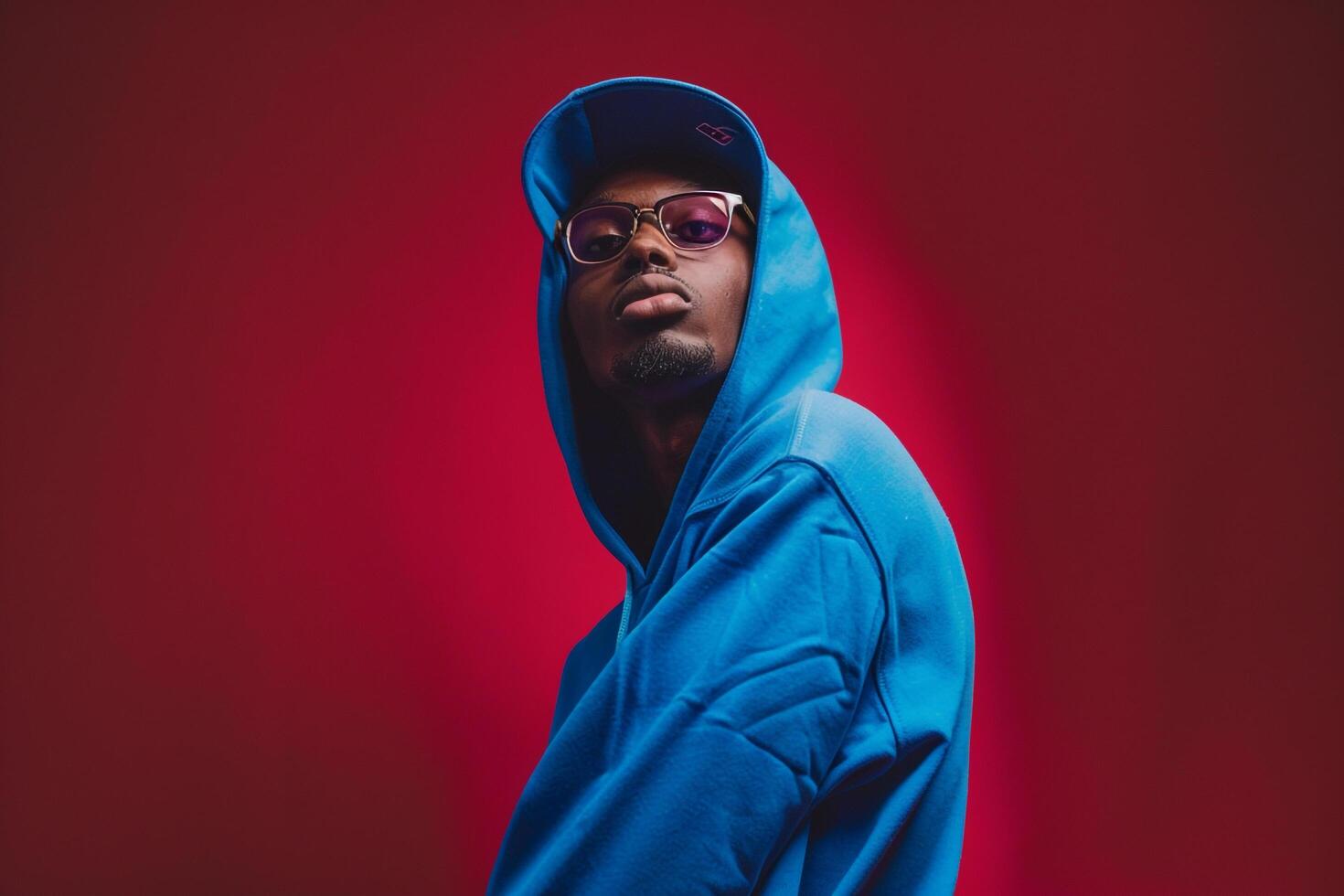 Bright Blue Hoodie with Sunglasses Urban Lifestyle portrait Featuring Dark Burgundy Trendy Male Fashion Details photo