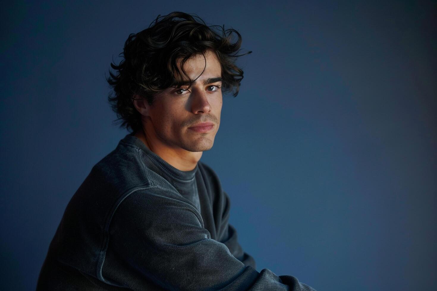 elegant Males fashion with an indigo blue pullover capturing a refined lifestyle in a modern portrait with a compleMaletary background photo