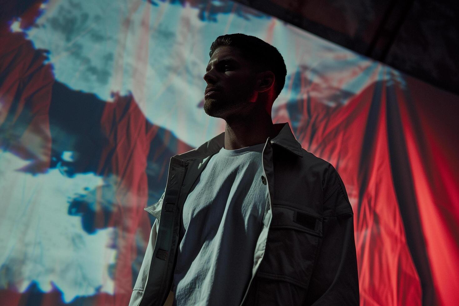 Dramatic Jacket with Dark Abstract Art Trendy Male Model portrait Against Artistic Background emphasizing Contemporary Males Lifestyle photo