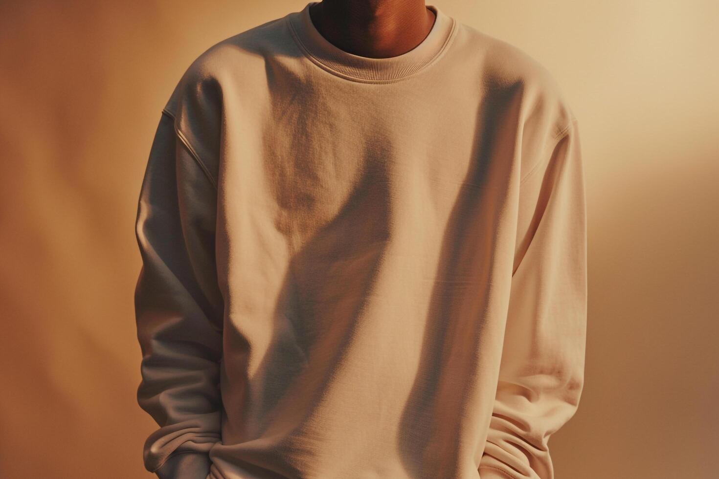 Handsome male in a comfortable sweatshirt earthy tan background relaxed portrait sweatshirt details casual style photo