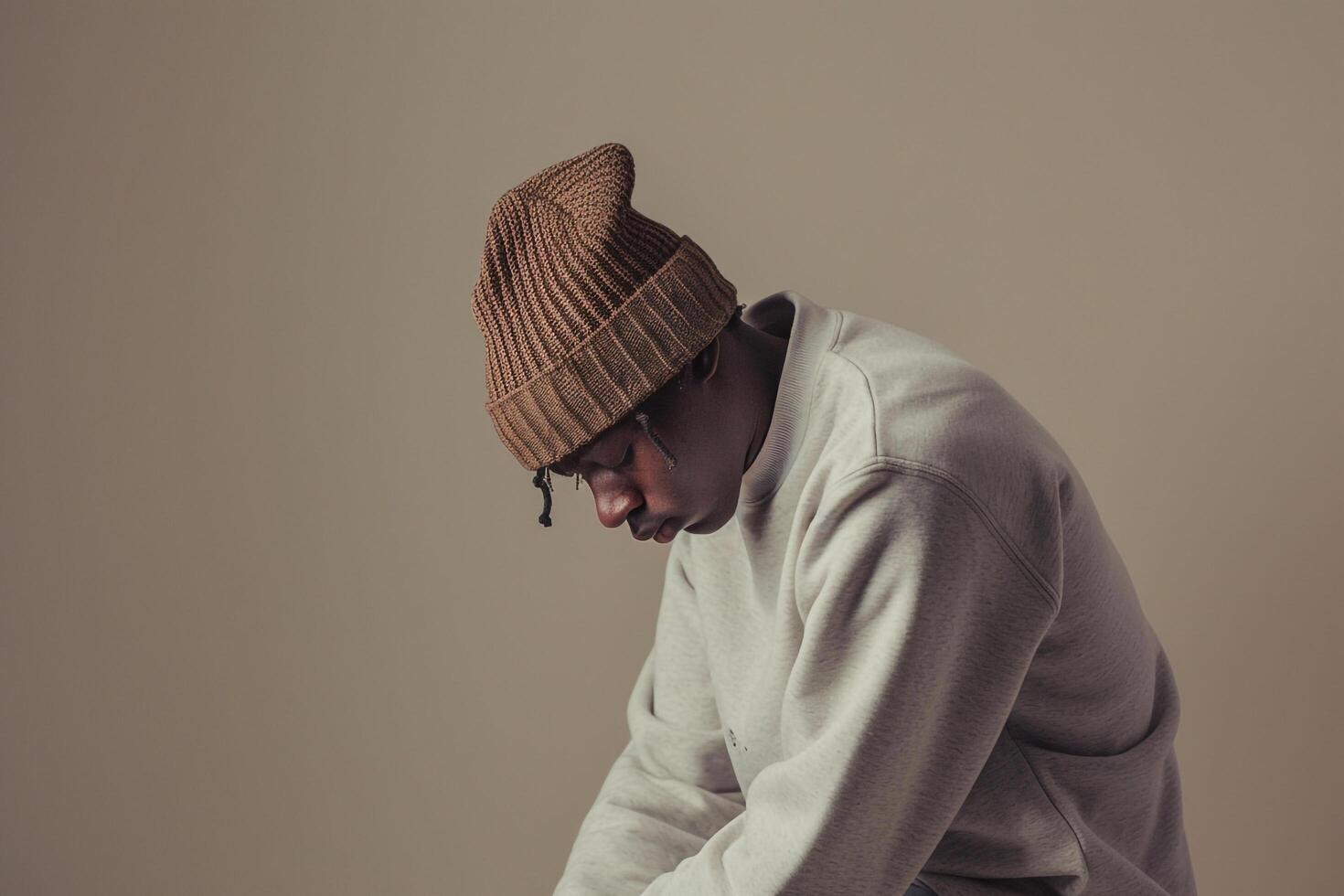 Stylish male fashion model in beige comfortable sweatshirt modern lifestyle relaxed and handsome portrait photo